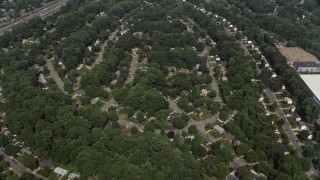 4.8K aerial stock footage of a bird's eye view of suburban homes and tree-lined streets, reveal shops in Springfield, Virginia Aerial Stock Footage | AX75_023E