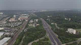 4.8K aerial stock footage of light traffic on Interstate 95, industrial buildings and shops by train tracks, Alexandria, Virginia Aerial Stock Footage | AX75_028E