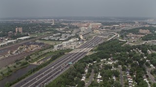 4.8K aerial stock footage flying by Interstate 95 between train yard and suburban homes in Alexandria, Virginia Aerial Stock Footage | AX75_033E