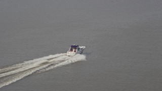 AX75_047 - 4.8K aerial stock footage tracking a speedboat cruising on the Potomac River in Washington DC