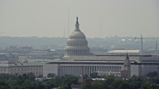 AX75_056E - 4.8K aerial stock footage of the United States Capitol dome behind Cannon House Offices and James Madison Building in Washington DC