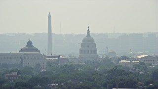 AX75_062E - 4.8K aerial stock footage of the United States Capitol and the Thomas Jefferson Building domes behind the John Adams Building in Washington DC