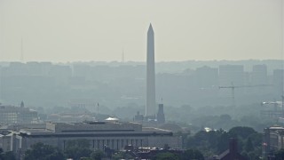 4.8K aerial stock footage of the Washington Monument seen over rooftops in Washington DC Aerial Stock Footage | AX75_066