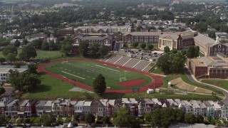 AX75_109 - 4.8K aerial stock footage of McKinley Technology High School and football field in Washington DC