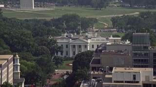 4.8K aerial stock footage of the White House seen over office building rooftops, reveal Washington Monument in Washington DC Aerial Stock Footage | AX75_111E