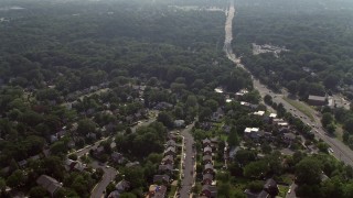 AX75_143E - 4.8K aerial stock footage approaching and flying over suburban homes next to Highway 50 in Arlington, Virginia