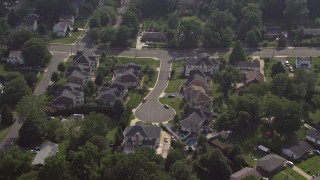 4.8K aerial stock footage approaching and tilting to bird's eye of suburban cul-de-sac and homes in Annandale, Virginia Aerial Stock Footage | AX75_151