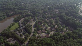 4.8K aerial stock footage tilting to a bird's eye view of tract and row houses beside Lake Barton in Burke, Virginia Aerial Stock Footage | AX75_163