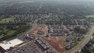 4.8K aerial stock footage flying over homes and streets to approach strip mall and stores in Manassas, Virginia Aerial Stock Footage | AX75_171E