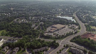 4.8K aerial stock footage flying over homes, row house, and a strip mall on Hasting Drive in Manassas, Virginia Aerial Stock Footage | AX75_173E