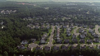 4.8K aerial stock footage flying over suburban homes to approach warehouse buildings in Manassas, Virginia Aerial Stock Footage | AX75_175