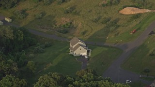 4.8K aerial stock footage flying by a home, green lawns, Manassas, Virginia, sunset Aerial Stock Footage | AX76_006