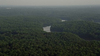 4.8K aerial stock footage flying by Occoquan River winding through forest, Clifton, Virginia, sunset Aerial Stock Footage | AX76_010