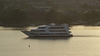 4.8K aerial stock footage tracking a ferry sailing the Potomac River, Alexandria, Virginia, sunset Aerial Stock Footage | AX76_034