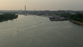 4.8K aerial stock footage approaching sailboats and ferry on Washington Channel near Washington Monument, Washington D.C., sunset Aerial Stock Footage | AX76_040E