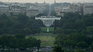 AX76_047E - 4.8K aerial stock footage flying by The White House and Washington Monument, Washington D.C., sunset