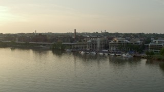 AX76_053 - 4.8K aerial stock footage approaching Ritz-Carlton Residences and Washington Harbour, by the Potomac River, in Georgetown, Washington D.C., sunset