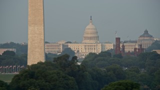 4.8K aerial stock footage flying by United States Capitol, Smithsonian Museum domes, and cranes, Washington D.C., sunset Aerial Stock Footage | AX76_056E