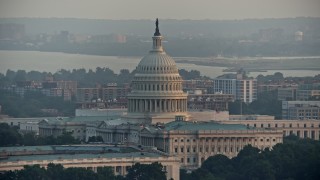 AX76_085 - 4.8K aerial stock footage of the dome of the United States Capitol, Washington D.C., sunset