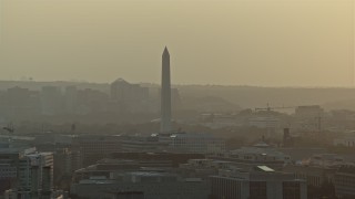 4.8K aerial stock footage of the Washington Monument and office buildings in Washington D.C., sunset Aerial Stock Footage | AX76_092