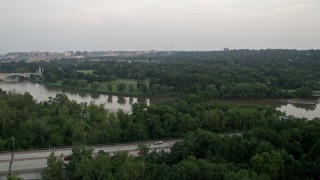 4.8K aerial stock footage approaching Lady Bird Johnson Park and Arlington National Cemetery, Washington D.C., sunset Aerial Stock Footage | AX76_110