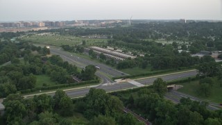 4.8K aerial stock footage approaching parking structure and Visitors Center at Arlington National Cemetery, Virginia, sunset Aerial Stock Footage | AX76_112