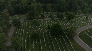 4.8K aerial stock footage flying over Arlington National Cemetery, tilt to gravestones, Virginia, twilight Aerial Stock Footage | AX76_118