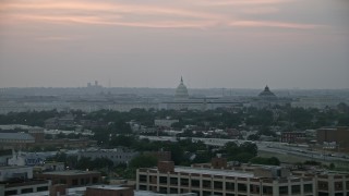 AX76_143 - 4.8K aerial stock footage of the United States Capitol dome, Library of Congress, and House office buildings, Washington, D.C., twilight