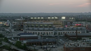 AX76_144 - 4.8K aerial stock footage approaching Nationals Park from the Anacostia River during a baseball game, Washington, D.C., twilight