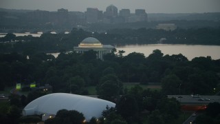 AX76_178 - 4.8K aerial stock footage approaching the Jefferson Memorial beside Tidal Basin, Washington, D.C., twilight