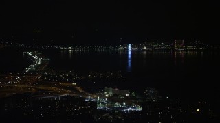 AX77_008 - 4.8K aerial stock footage of the Capitol Wheel and Gaylord National Resort & Convention Center across the Potomac, National Harbor, Maryland, night