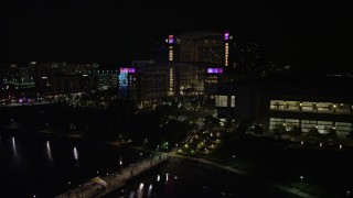 4.8K aerial stock footage flying by pier and Gaylord National Resort & Convention Center, National Harbor, Maryland, night Aerial Stock Footage | AX77_014