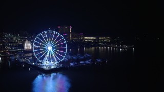 AX77_016 - 4.8K aerial stock footage approaching Capitol Wheel, marina, and Gaylord National Resort and Convention Center, National Harbor, Maryland, night