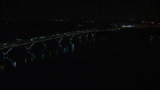 AX77_020 - 4.8K aerial stock footage of light traffic on Woodrow Wilson Memorial Bridge over the Potomac River, Fort Washington, Maryland, night