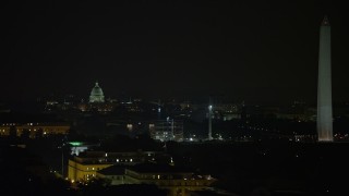 4.8K aerial stock footage of the United States Capitol dome, construction cranes, and the Washington Monument, Washington, D.C., night Aerial Stock Footage | AX77_052