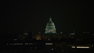 AX77_054 - 4.8K aerial stock footage of the United States Capitol building in Washington, D.C., night