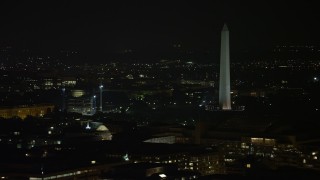 4.8K aerial stock footage of Washington Monument ringed by flags in Washington, D.C., night Aerial Stock Footage | AX77_063