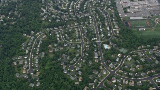 4.8K aerial stock footage of a reverse view of suburban homes, roads, trees, Herndon, Virginia Aerial Stock Footage | AX78_033E