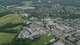 AX78_060E - 4.8K aerial stock footage tilting from State Route 32 to reveal car dealerships, stores, and suburban homes in Clarksville, Maryland