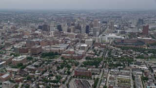 4.8K aerial stock footage tilting from urban homes and streets to reveal and approach Downtown Baltimore skyscrapers, Maryland Aerial Stock Footage | AX78_084E