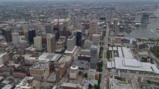 AX78_087E - 4.8K aerial stock footage approaching Downtown Baltimore skyscrapers by the Baltimore Convention Center in Maryland