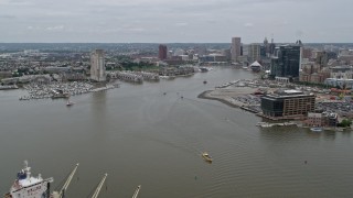 4.8K aerial stock footage flying over cargo ship to approach Inner Harbor area of Downtown Baltimore, Maryland Aerial Stock Footage | AX78_106E