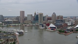 AX78_108E - 4.8K aerial stock footage of Downtown Baltimore skyscrapers, Inner Harbor piers, and the National Aquarium, Maryland