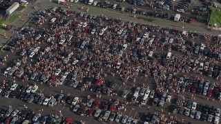 4.8K aerial stock footage of crowds tailgaiting  in a parking lot, Campbell's Field, Camden, New Jersey Aerial Stock Footage | AX79_091E