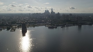 AX79_096 - 4.8K aerial stock footage flying over Delaware River to approach Downtown Philadelphia skyline, Pennsylvania