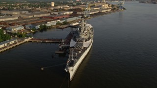 AX80_001 - 4.8K aerial stock footage of the USS New Jersey on the Delaware River, Camden, New Jersey, Sunset