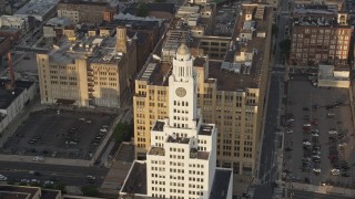 4.8K aerial stock footage of the Inquirer Building clock tower in Downtown Philadelphia, Pennsylvania, Sunset Aerial Stock Footage | AX80_047