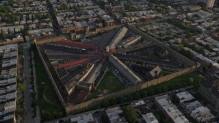 4.8K aerial stock footage flying by Eastern State Penitentiary in Philadelphia, Pennsylvania at Sunset Aerial Stock Footage | AX80_051