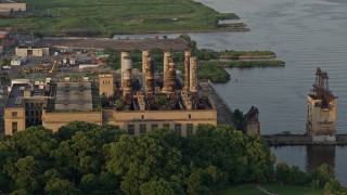 4.8K aerial stock footage of an abandoned factory by the Delaware River, North Philadelphia, Pennsylvania Sunset Aerial Stock Footage | AX80_073