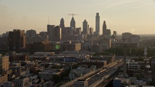 4.8K aerial stock footage approaching the Downtown Philadelphia skyline in Pennsylvania, Sunset Aerial Stock Footage | AX80_077